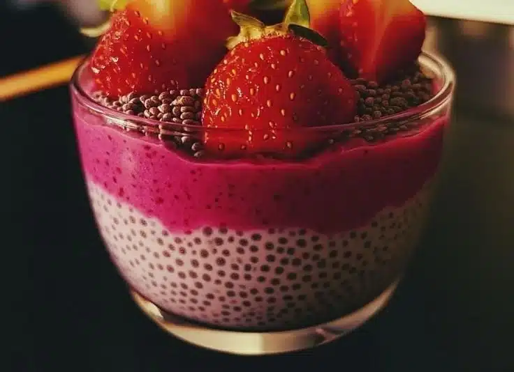 Delicious strawberry chia pudding served in a glass bowl topped with fresh strawberries